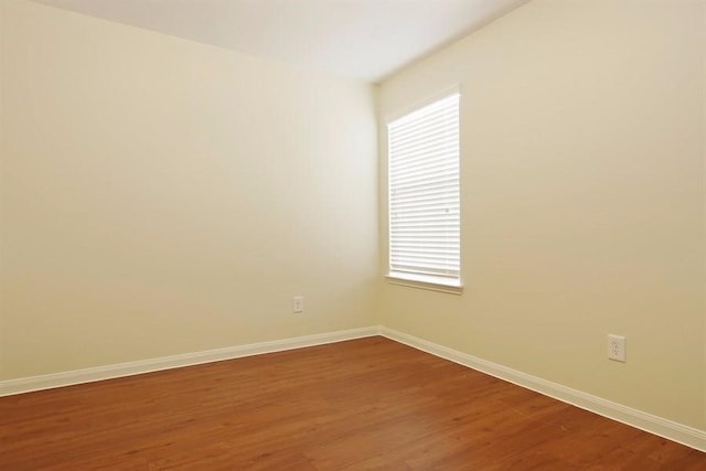 15415 Bammel Oaks Ct, Houston, TX 77014 - unfurnished room featuring baseboards, dark wood finished floors, and healthy amount of natural light