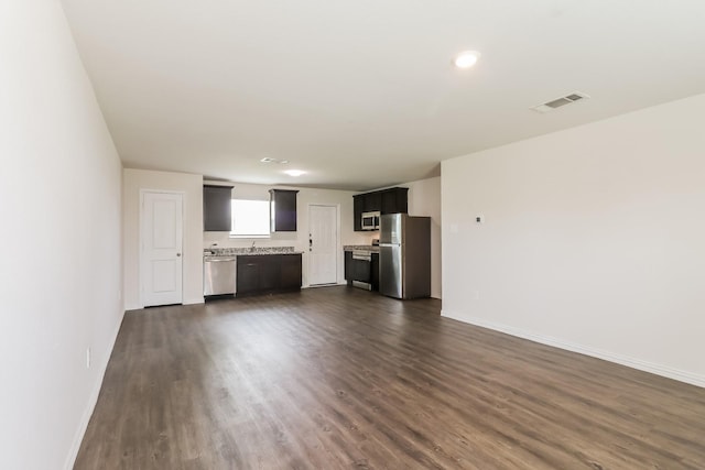 7945 Henson St, Houston, TX 77028 - unfurnished living room with dark wood-style flooring and baseboards