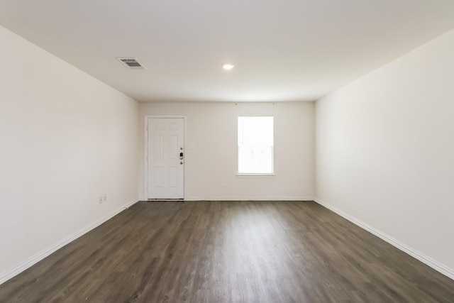 7945 Henson St, Houston, TX 77028 - empty room featuring dark wood-style flooring, baseboards, and recessed lighting