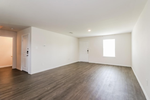 7945 Henson St, Houston, TX 77028 - empty room with dark wood-style flooring, baseboards, and recessed lighting