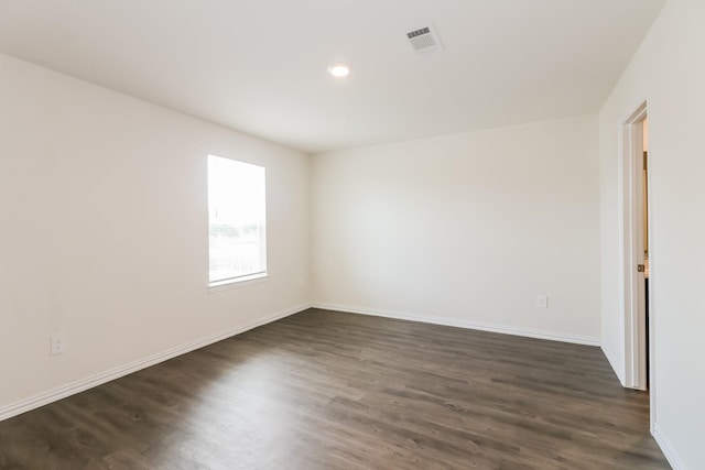 7945 Henson St, Houston, TX 77028 - empty room with dark wood-type flooring, baseboards, and recessed lighting