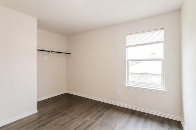 7945 Henson St, Houston, TX 77028 - empty room with dark wood-type flooring and baseboards