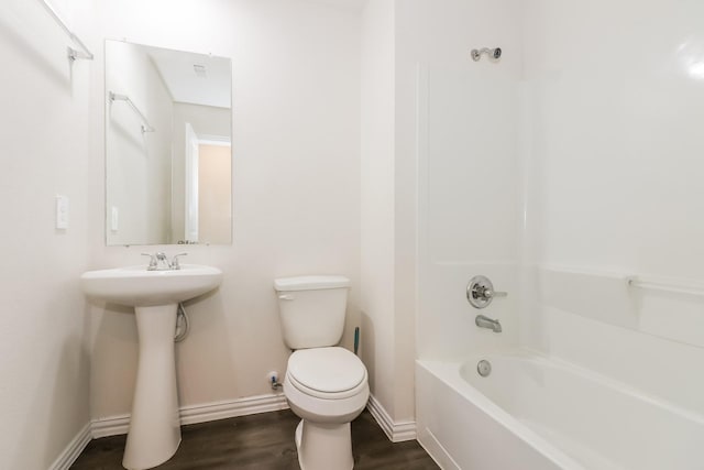 7945 Henson St, Houston, TX 77028 - full bathroom featuring toilet, baseboards, wood finished floors, bathing tub / shower combination, and a sink