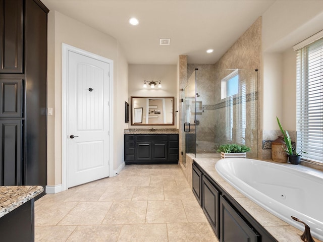 8322 Sands Bank Ln, Conroe, TX 77304 - bathroom with a shower stall, healthy amount of natural light, a tub with jets, vanity, and recessed lighting