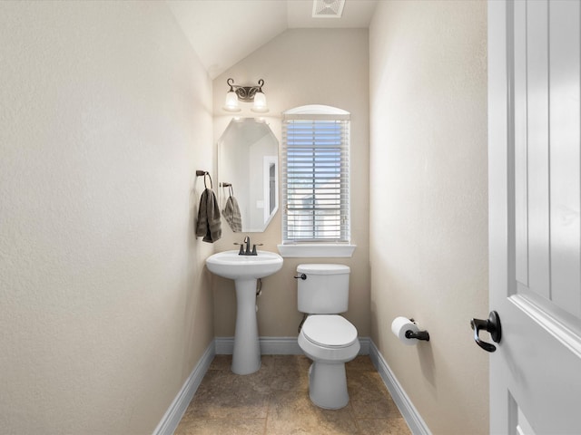8322 Sands Bank Ln, Conroe, TX 77304 - half bathroom with vaulted ceiling, toilet, and baseboards