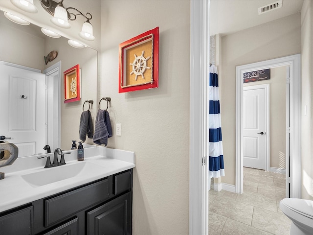 8322 Sands Bank Ln, Conroe, TX 77304 - bathroom with vanity, toilet, tile patterned floors, baseboards, and a shower with shower curtain