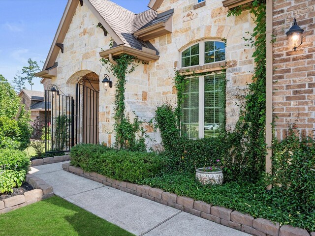 8322 Sands Bank Ln, Conroe, TX 77304 - view of exterior entry featuring stone siding and roof with shingles