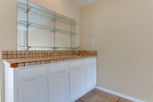 4035 Green Crst, Houston, TX 77082 - bar area featuring a sink, light tile patterned floors, and baseboards