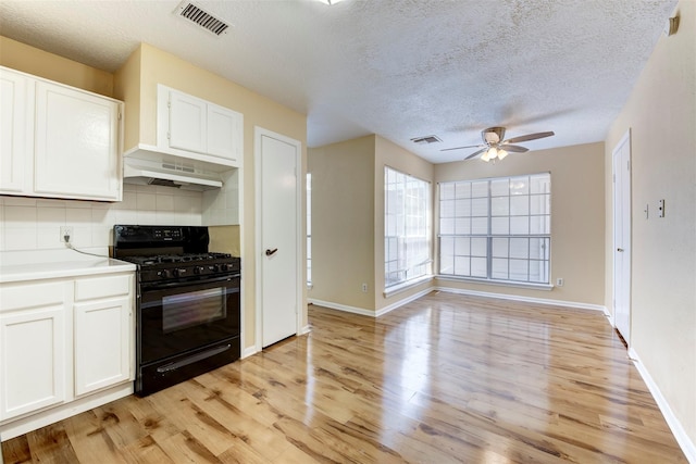 4035 Green Crst, Houston, TX 77082 - kitchen featuring gas stove, range hood, ceiling fan, light wood finished floors, and a textured ceiling
