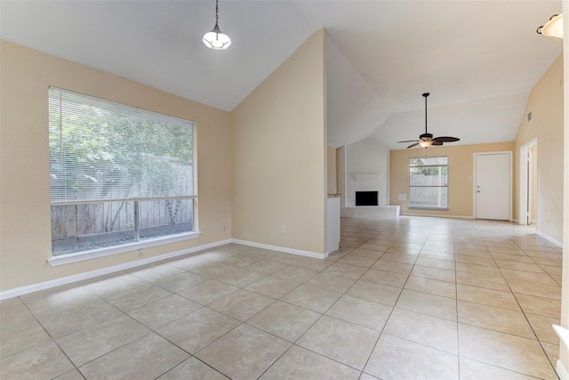 4035 Green Crst, Houston, TX 77082 - unfurnished living room featuring light tile patterned flooring, lofted ceiling, a ceiling fan, a large fireplace, and baseboards