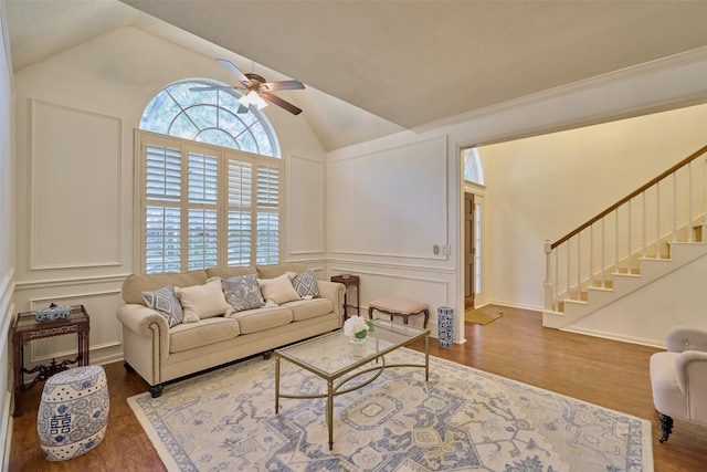 26 E Sterling Pond Cir, The Woodlands, TX 77382 - living room featuring stairway, a ceiling fan, vaulted ceiling, a decorative wall, and wood finished floors