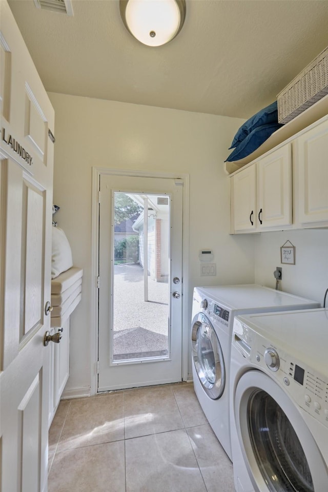 26 E Sterling Pond Cir, The Woodlands, TX 77382 - washroom with washing machine and dryer, cabinet space, and light tile patterned flooring