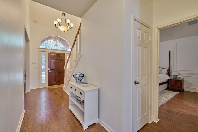 26 E Sterling Pond Cir, The Woodlands, TX 77382 - entryway featuring a chandelier, a towering ceiling, dark wood-type flooring, and stairway