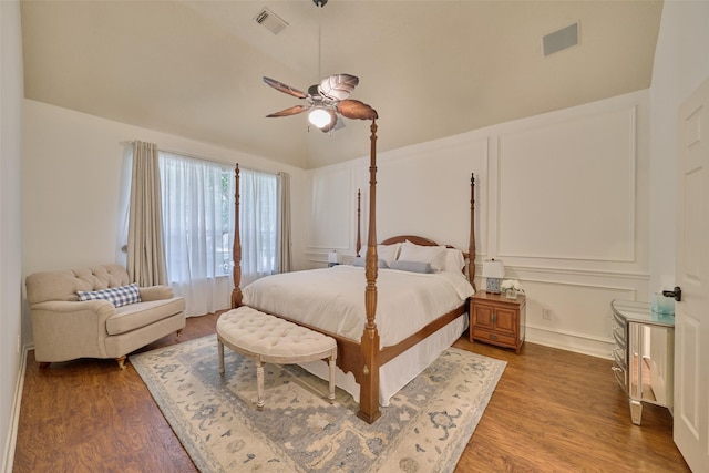 26 E Sterling Pond Cir, The Woodlands, TX 77382 - bedroom featuring wood finished floors, a decorative wall, a ceiling fan, and lofted ceiling