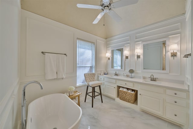 26 E Sterling Pond Cir, The Woodlands, TX 77382 - bathroom featuring double vanity, a freestanding tub, ceiling fan, and a decorative wall