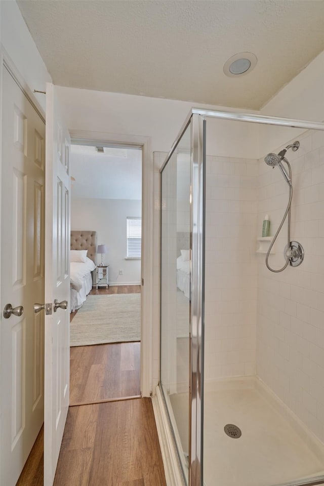 26 E Sterling Pond Cir, The Woodlands, TX 77382 - ensuite bathroom featuring a shower stall and wood finished floors