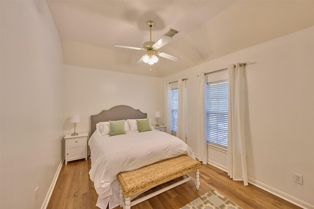 26 E Sterling Pond Cir, The Woodlands, TX 77382 - bedroom featuring baseboards, wood finished floors, and a ceiling fan