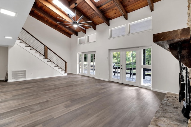 118 Glenview, Livingston, TX 77351 - unfurnished living room featuring wooden ceiling with exposed beams, french doors, wood finished floors, a ceiling fan, and high vaulted ceiling