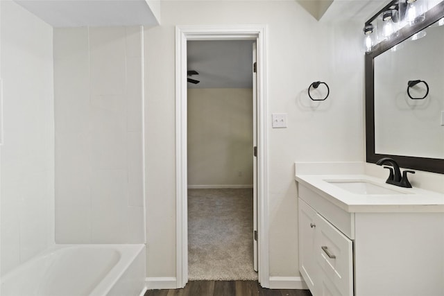 118 Glenview, Livingston, TX 77351 - bathroom featuring vanity, wood finished floors, baseboards, and shower / bathtub combination