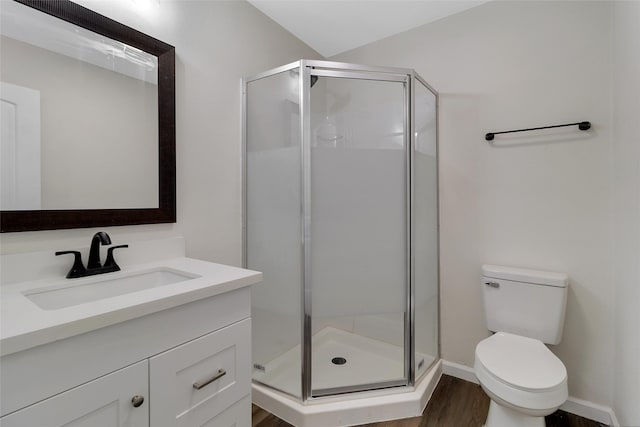 118 Glenview, Livingston, TX 77351 - bathroom with vanity, toilet, a shower stall, wood finished floors, and baseboards