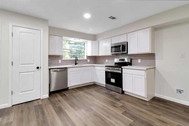118 Glenview, Livingston, TX 77351 - kitchen with appliances with stainless steel finishes, a sink, light countertops, wood finished floors, and recessed lighting