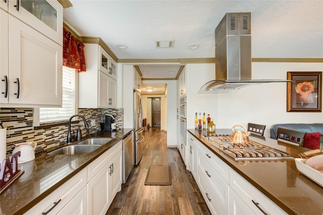 4603 New Orleans St, Houston, TX 77020 - kitchen with island exhaust hood, a sink, dark wood-style floors, ornamental molding, and stainless steel appliances