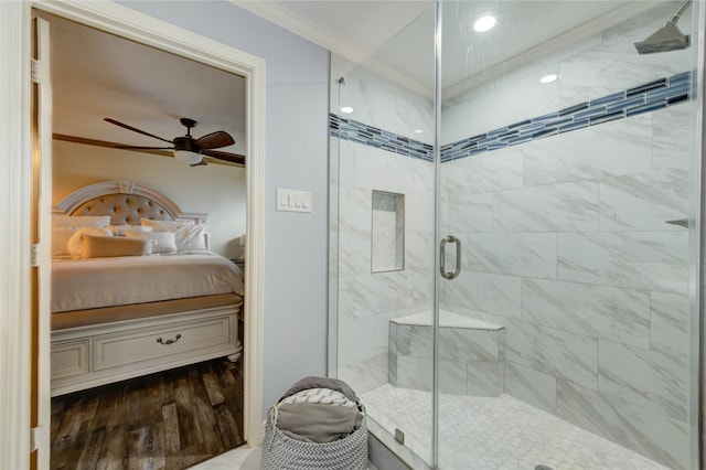 4603 New Orleans St, Houston, TX 77020 - ensuite bathroom featuring crown molding, a ceiling fan, a stall shower, and wood finished floors