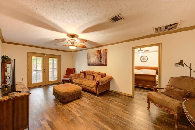 4603 New Orleans St, Houston, TX 77020 - living room with crown molding, french doors, a ceiling fan, wood finished floors, and a textured ceiling