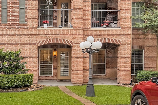 2815 Kings Crossing Dr Unit 102, Houston, TX 77345 - entrance to property with brick siding and a balcony