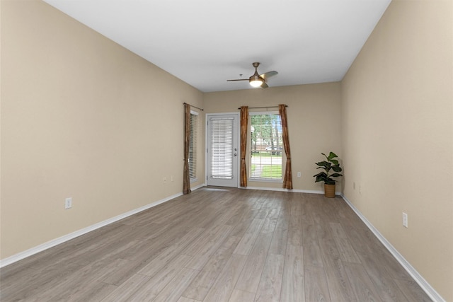 2815 Kings Crossing Dr Unit 102, Houston, TX 77345 - spare room featuring a ceiling fan, light wood-style floors, and baseboards