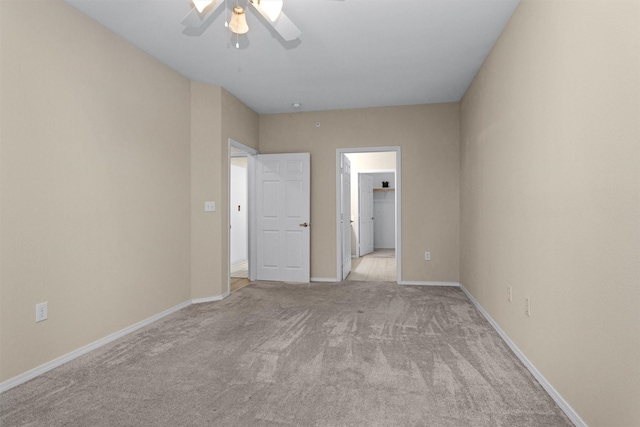 2815 Kings Crossing Dr Unit 102, Houston, TX 77345 - unfurnished bedroom with light carpet, baseboards, and a ceiling fan