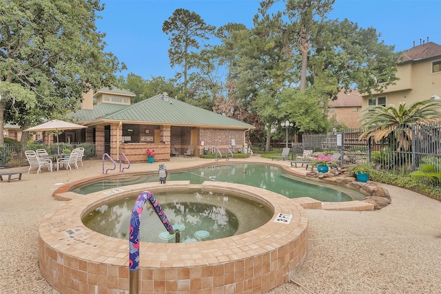 2815 Kings Crossing Dr Unit 102, Houston, TX 77345 - view of swimming pool featuring a patio and a pool with connected hot tub