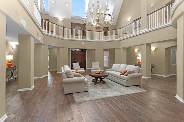 2815 Kings Crossing Dr Unit 102, Houston, TX 77345 - living room featuring a towering ceiling, wood finished floors, baseboards, and a chandelier