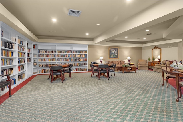 2815 Kings Crossing Dr Unit 102, Houston, TX 77345 - sitting room with a tray ceiling, carpet floors, wall of books, and recessed lighting