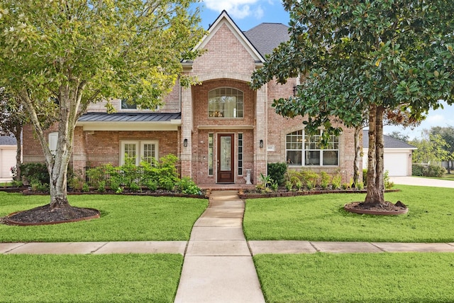 3505 Parkside Dr, Pearland, TX 77584 - traditional-style house with brick siding, a standing seam roof, a front lawn, and a garage