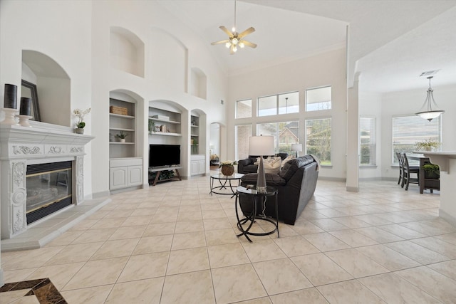3505 Parkside Dr, Pearland, TX 77584 - living room with built in shelves, a high ceiling, plenty of natural light, ceiling fan, and light tile patterned flooring