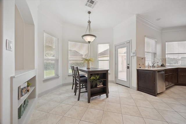 3505 Parkside Dr, Pearland, TX 77584 - dining space featuring ornamental molding, light tile patterned floors, and arched walkways