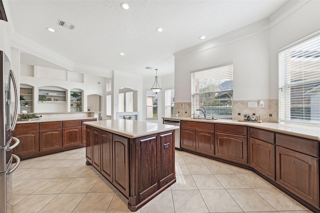 3505 Parkside Dr, Pearland, TX 77584 - kitchen with crown molding, appliances with stainless steel finishes, a sink, light countertops, and backsplash