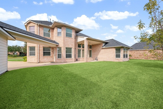 3505 Parkside Dr, Pearland, TX 77584 - rear view of house featuring brick siding, a lawn, a patio, and roof with shingles