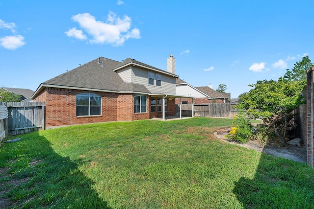 22610 Torrisdale Ln, Tomball, TX 77375 - back of property featuring brick siding, a chimney, a fenced backyard, and roof with shingles
