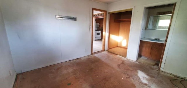 6136 25th St, Groves, TX 77619 - unfurnished bedroom featuring concrete floors, a sink, and a closet