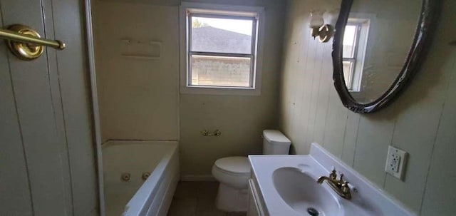 6136 25th St, Groves, TX 77619 - bathroom featuring toilet, baseboards, tile patterned flooring, and vanity