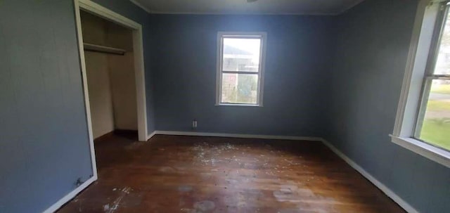 6136 25th St, Groves, TX 77619 - unfurnished bedroom featuring baseboards, a closet, and wood finished floors