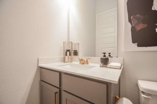 10711 Kingston Spring Dr, Missouri City, TX 77459 - half bath featuring vanity, toilet, and a textured wall