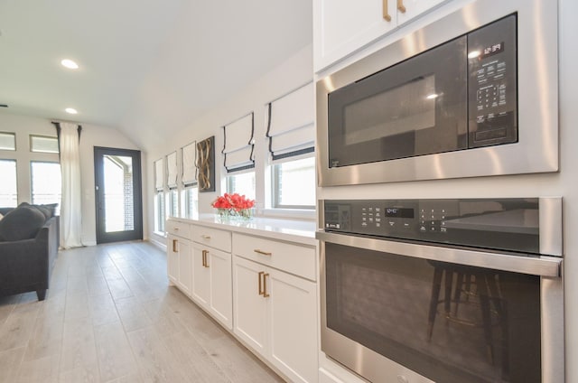10711 Kingston Spring Dr, Missouri City, TX 77459 - kitchen with built in microwave, oven, white cabinetry, healthy amount of natural light, and recessed lighting