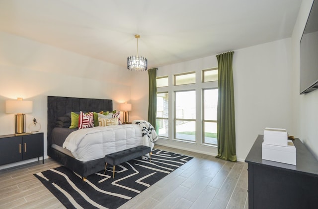 10711 Kingston Spring Dr, Missouri City, TX 77459 - bedroom featuring light wood-style floors and a chandelier