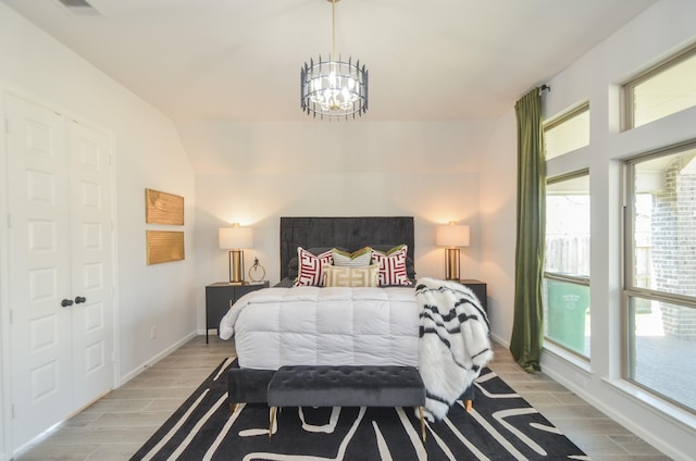 10711 Kingston Spring Dr, Missouri City, TX 77459 - bedroom featuring a chandelier, light wood-type flooring, and baseboards