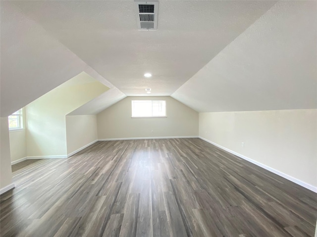 301 Old Bayou Dr, Dickinson, TX 77539 - bonus room with wood finished floors, lofted ceiling, and a textured ceiling