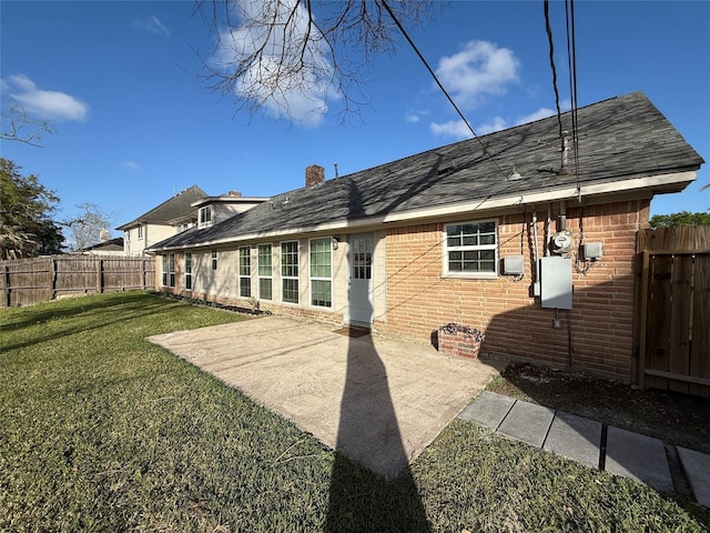 301 Old Bayou Dr, Dickinson, TX 77539 - rear view of house with brick siding, a fenced backyard, and roof with shingles