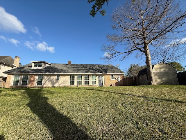 301 Old Bayou Dr, Dickinson, TX 77539 - back of property with a storage unit, brick siding, and a chimney